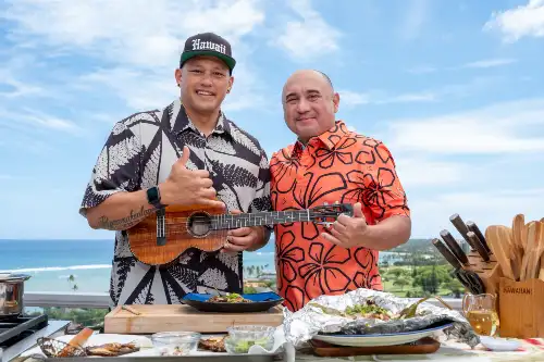 Whole roasted Isaiah Tavares Mū fish cooked in foil with savory toppings