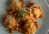 Biscuits & ʻUlu Gravy By Chef Mare Wills Plated savory biscuits smothered in creamy ʻulu and Portuguese sausage gravy, garnished with green onions.