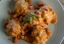 Biscuits & ʻUlu Gravy By Chef Mare Wills Plated savory biscuits smothered in creamy ʻulu and Portuguese sausage gravy, garnished with green onions.
