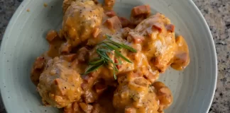 Biscuits & ʻUlu Gravy By Chef Mare Wills Plated savory biscuits smothered in creamy ʻulu and Portuguese sausage gravy, garnished with green onions.