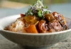 Papa Keoki’s Oxtail Stew by Zion Thompson A bowl of hearty Hawaiian-style Papa Keoki's Oxtail Stew made by Zion Thompson, featuring tender oxtails and potatoes.