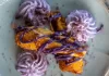 Ube Haupia Cheesecake Eggrolls By Chef Mari Wills Crispy ube haupia cheesecake eggrolls drizzled with purple ube sauce and served with whipped cream on a plate.
